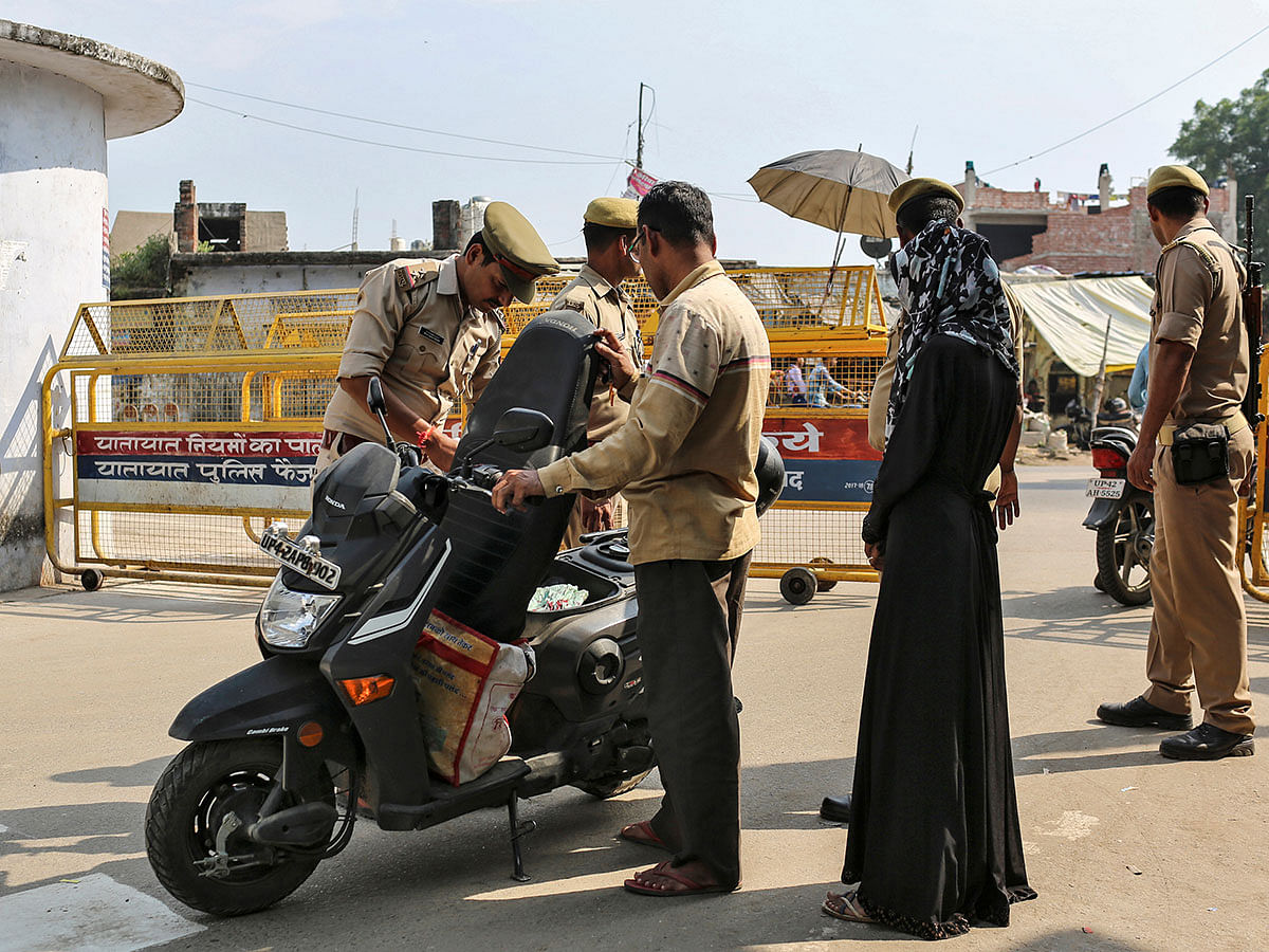 Policemen check a scooter at a security barricade on the road leading to a disputed religious site where Hindu religious groups are demanding the construction of a temple in Ayodhya, India, on 22 October 2019. Photo: Reuters