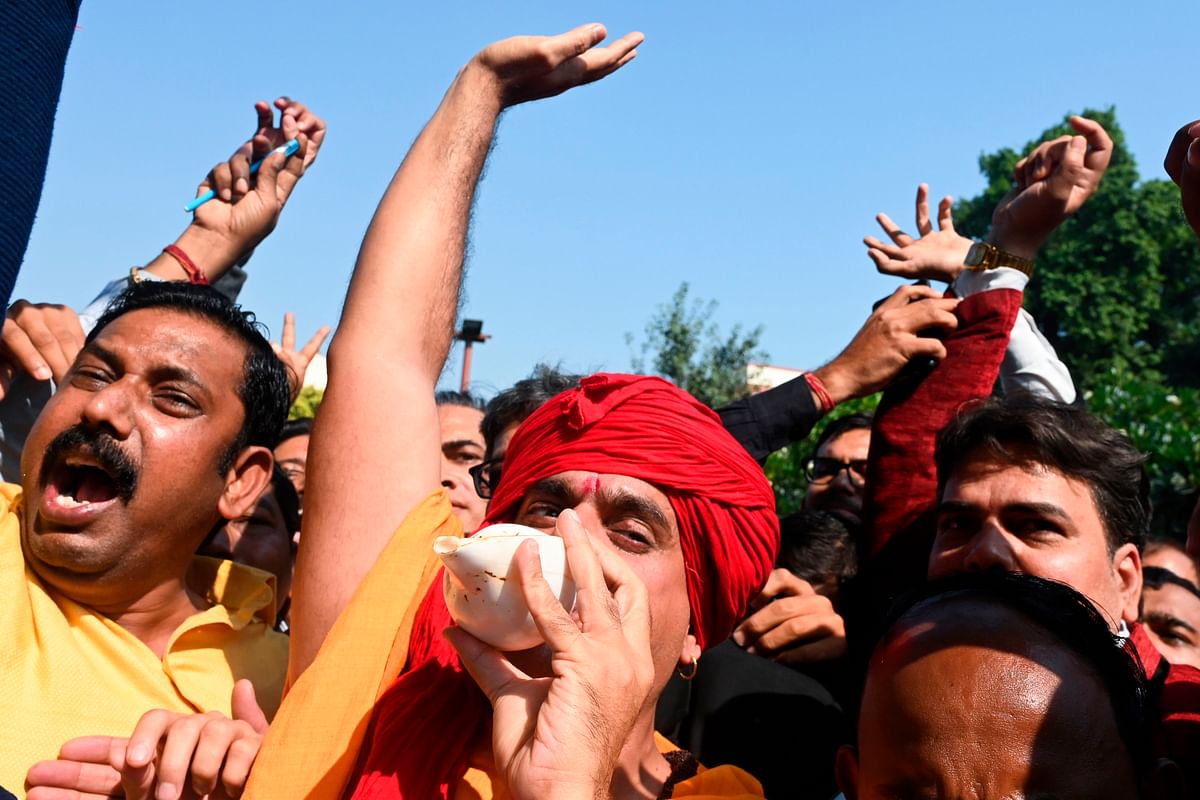 All India Hindu Mahasabha president Chakrapani Maharaj and supporters celebrate at the Supreme Court in New Delhi on 9 November 2019, after a ruling over a holy site contested for centuries by Hindus and Muslims. India`s top court handed on 9 November a huge victory to Prime Minister Narendra Modi`s Hindu nationalist ruling party by awarding Hindus control of a bitterly disputed holy site that has sparked deadly sectarian violence. Photo: AFP