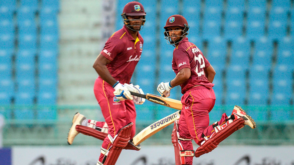 West Indies` Nicholas Pooran (R) and Romario Shepherd (L) run between the wickets during the second one day international (ODI) cricket match between Afghanistan and West Indies at the Ekana Cricket Stadium in Lucknow on Saturday. Photo: AFP