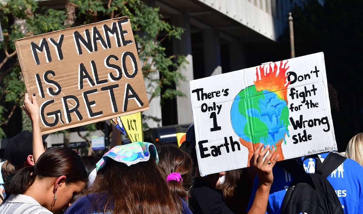 Activists hold placards before a march through downtown Los Angeles during a climate change rally where teenage Swedish activist Greta Thunberg addressed the crowd in Los Angeles, California on 1 November 2019. Photo: AFP