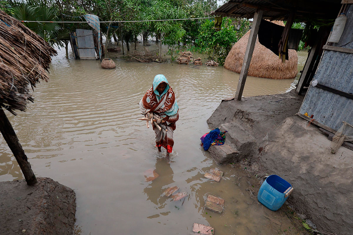 A woman walks through a water logged house after cyclone Bulbul hit the area in Koyra, some 100 km from Khulna on 10 November 2019. Photo: AFP