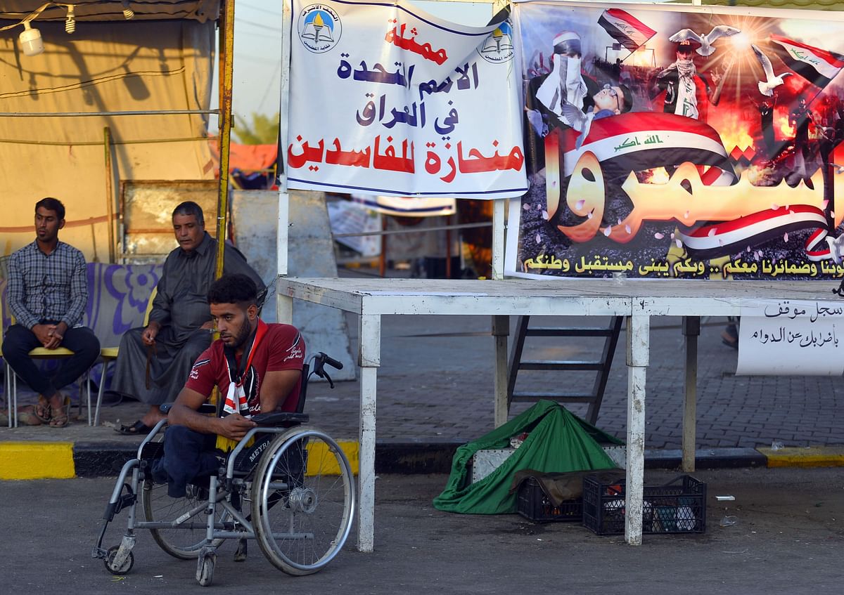 A handicapped man joins an anti-government protest in the central holy shrine city of Najaf, on 10 November. Photo: AFP