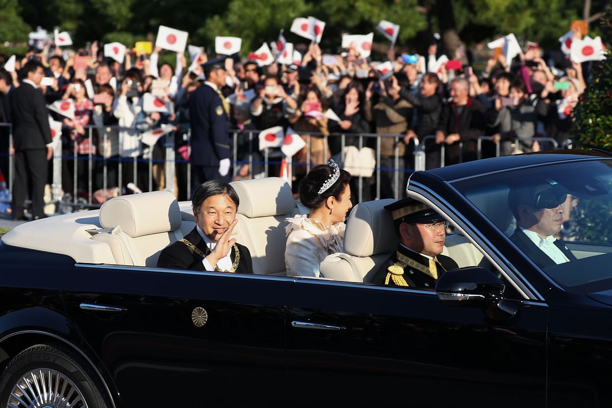Japan’s Emperor Naruhito (L) and Empress Masako (2nd L) wave during a royal parade in Tokyo on 10 November 2019. Photo: AFP