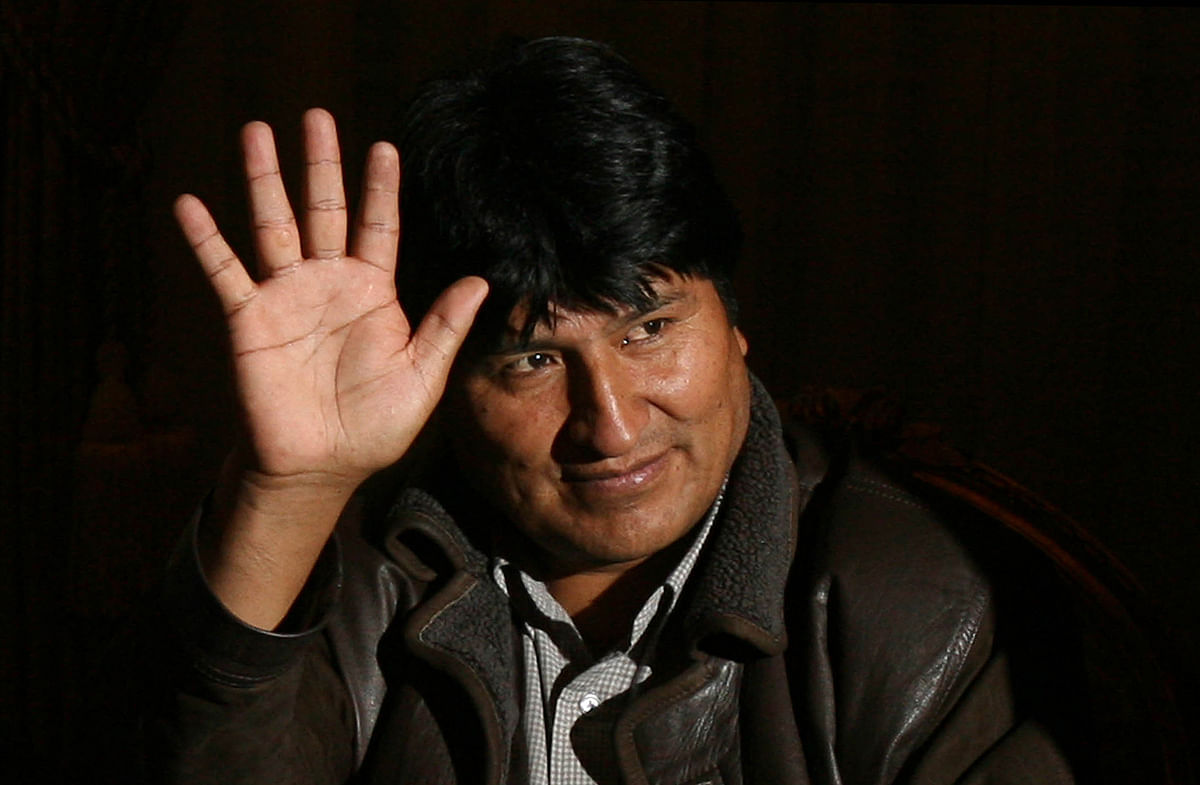 In this file handout picture released by the Venezuelan presidency and taken on 2 May 2006 Bolivian president Evo Morales waves to the press during a meeting with Venezuelan president Hugo Chavez (out of frame) at Quemado presidential Palace in La Paz. Photo: AFP