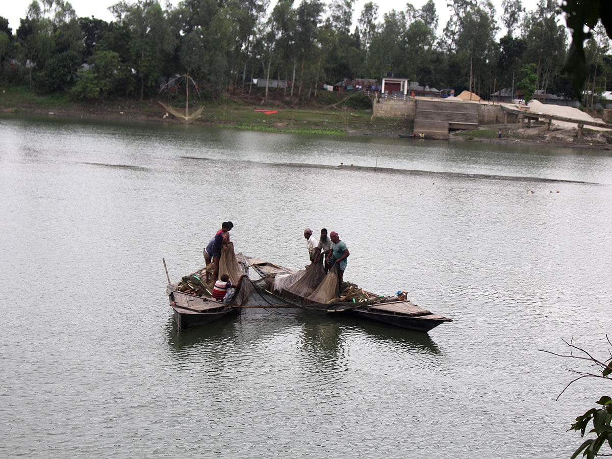 Fishermen catching fish with nets in river Jhinai in Boira of Sharishabari, Jamalpur on 12 November 2019. Photo: Shafiqul Islam
