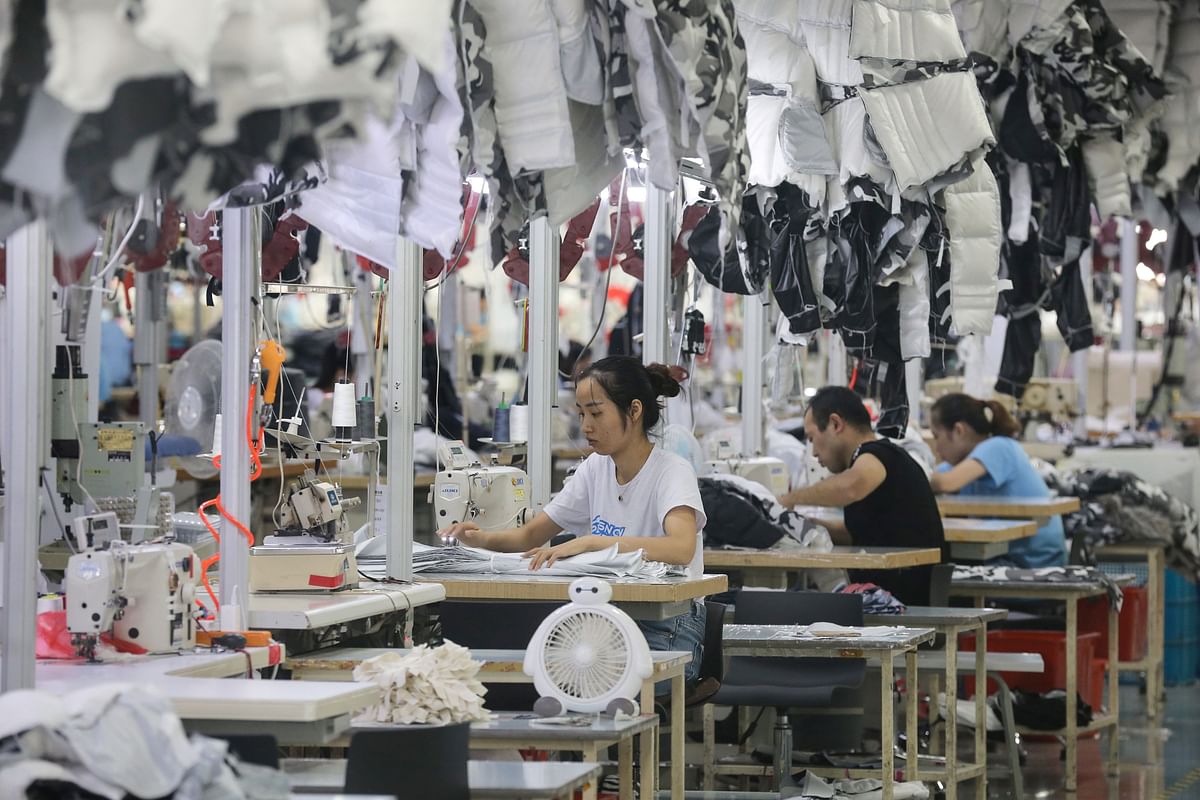 This file photo taken on 24 September 2019 shows employees producing down coats at a factory for Chinese clothing company Bosideng in Nantong in China`s eastern Jiangsu province. Photo: AFP