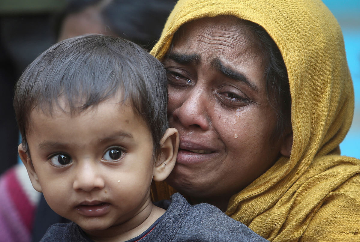 A Rohingya Muslim woman cries as she holds her daughter after they were detained by Border Security Force (BSF) soldiers while crossing the India-Bangladesh border from Bangladesh, at Raimura village on the outskirts of Agartala, on 22 January 2019. Reuters File Photo