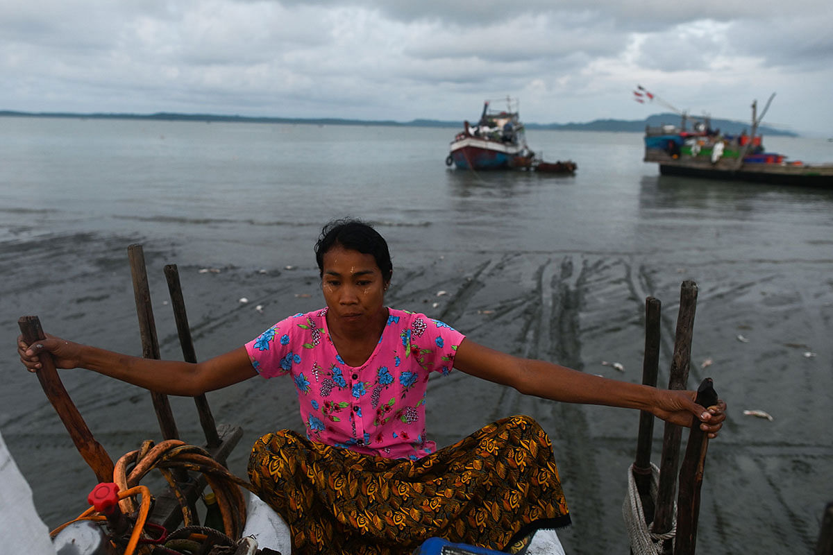 This photo taken on 1 October 2019 shows a boat passenger with belongings riding a bull cart to the shore at Japanma jetty in Kyaukphyu in Rakhine state. Myanmar has declared Rakhine state -- associated by many worldwide with the military`s 2017 crackdown on Rohingya Muslims -- open for business. Photo: AFP