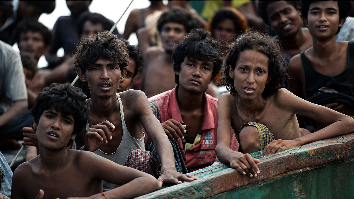 In this file photo taken on 14 May 2015 Rohingya migrants sit on a boat drifting in Thai waters off the southern island of Koh Lipe in the Andaman sea. Photo: AFP