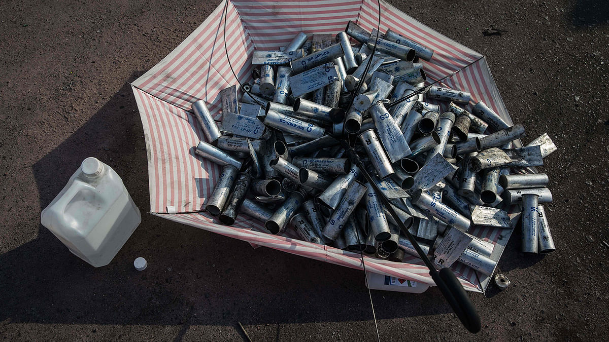 Used tear gas canisters are collected in an umbrella at the Chinese University of Hong Kong (CUHK) on 15 November 2019, after clashes between police and protesters on 12 November. Photo: AFP