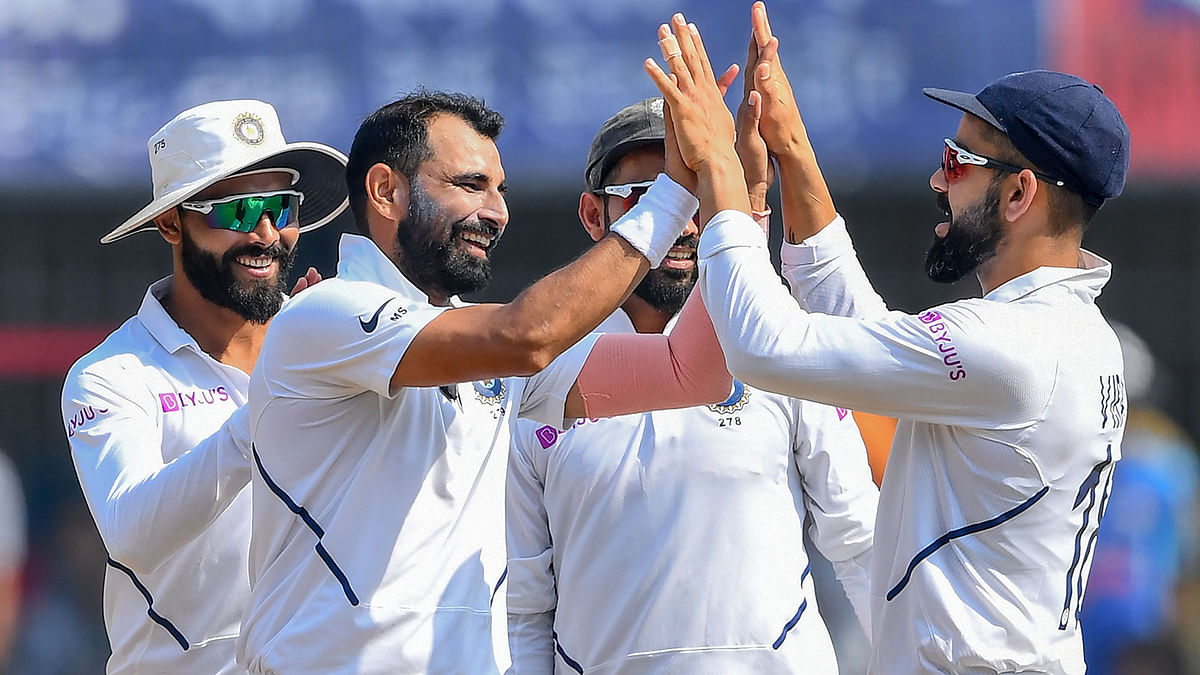 India`s Mohammed Shami (2L) celebrates with teammates after the dismissal of Bangladesh`s Mohammad Mithun during the third day of the first Test cricket match of a two-match series between India and Bangladesh at Holkar Cricket Stadium in Indore on 16 November, 2019. Photo: AFP