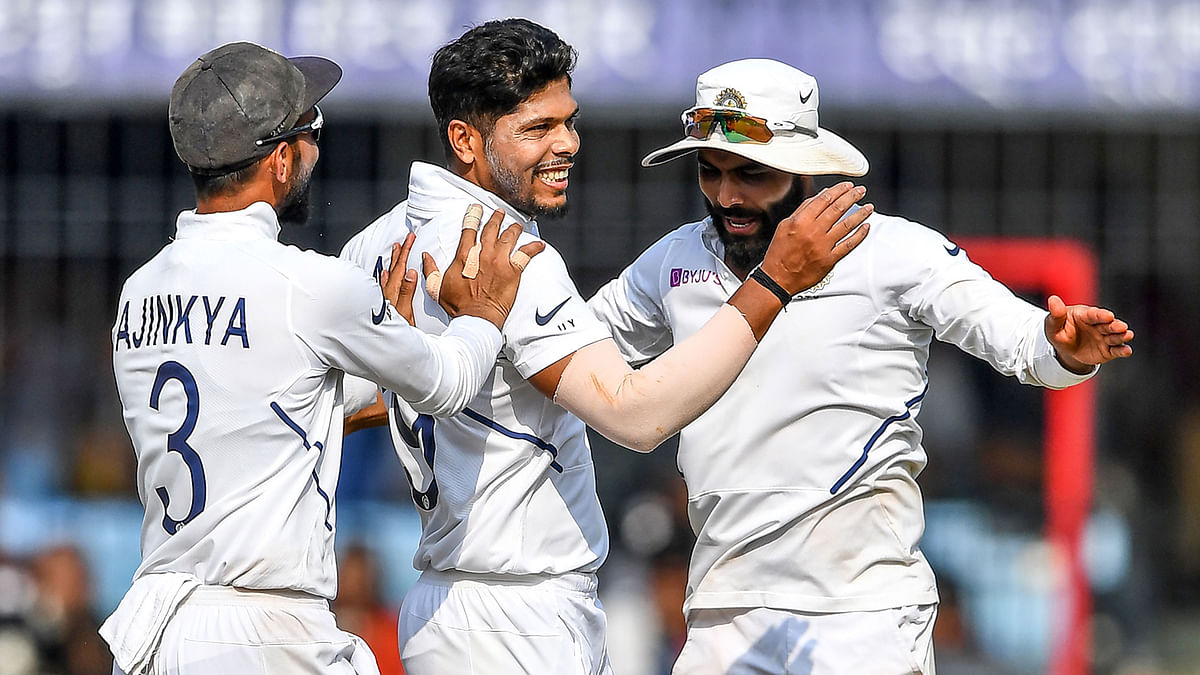 India`s Umesh Yadav (C) along with teammates Ajinkya Rahane (L) and Ravindra Jadeja celebrates after the dismissal of Bangladesh`s Mehidy Hasan during the third day of the first Test cricket match of a two-match series between India and Bangladesh at Holkar Cricket Stadium in Indore on November 16, 2019. AFP