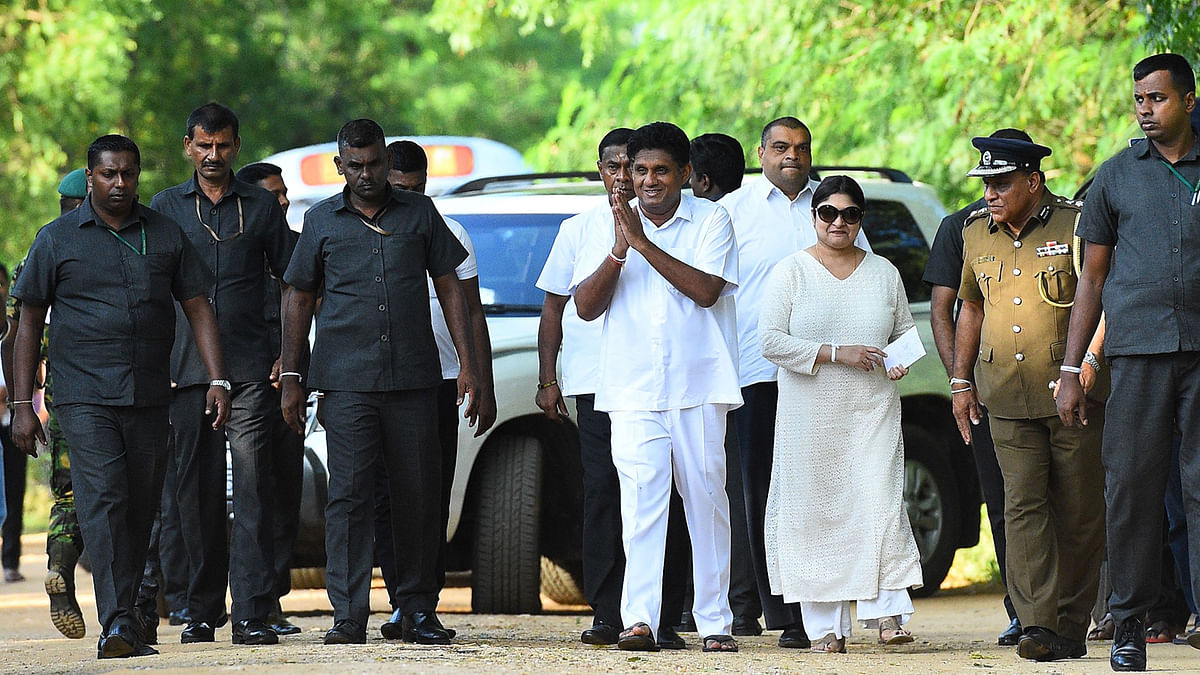 Deputy leader of the ruling United National Party (UNP) and New Democratic Front presidential candidate Sajith Premadasa (C) greets people ]outside a polling station after casting his vote during the country`s presidential election in Weerawila on 16 November 2019. Photo: AFP