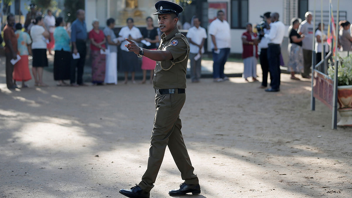 A police officer gestures at a polling station during the presidential election in Colombo. Photo: Reuters