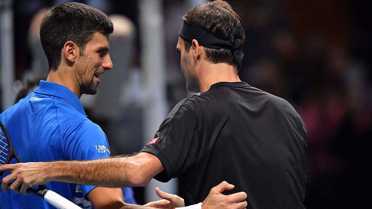 Switzerland`s Roger Federer (R) is congratulated by Serbia`s Novak Djokovic (L) after his straight sets win in their men`s singles round-robin match on day five of the ATP World Tour Finals tennis tournament at the O2 Arena in London on 14 November 2019. Photo: AFP