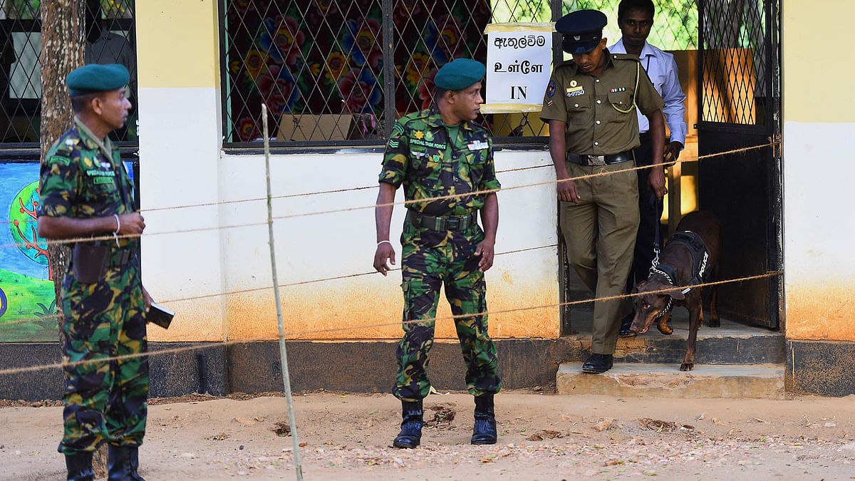 Security personnel check for explosives in a polling station during the country`s presidential election in Weerawila on 16 November 2019. Photo: AFP