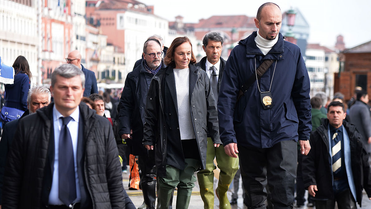 Italy’s Interior Minister Luciana Lamorgese (C) walk on a footbridge in Riva degli Schiavoni waterfront promenade on 16 November 2019 in Venice, three days after the city suffered the highest tide in 50 years. Photo: AFP