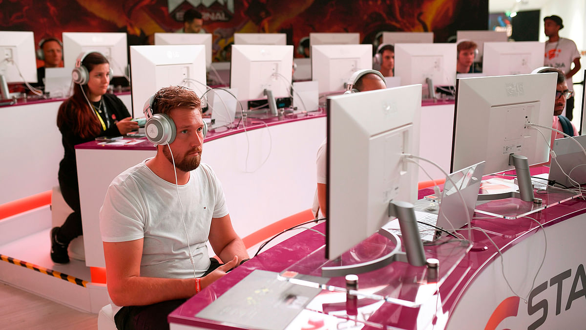 In this file photo taken on 21 August 2019 visitors play the cloud-game based `Doom` at the stand of Google Stadia during the Video games trade fair Gamescom in Cologne, western Germany. Photo: AFP