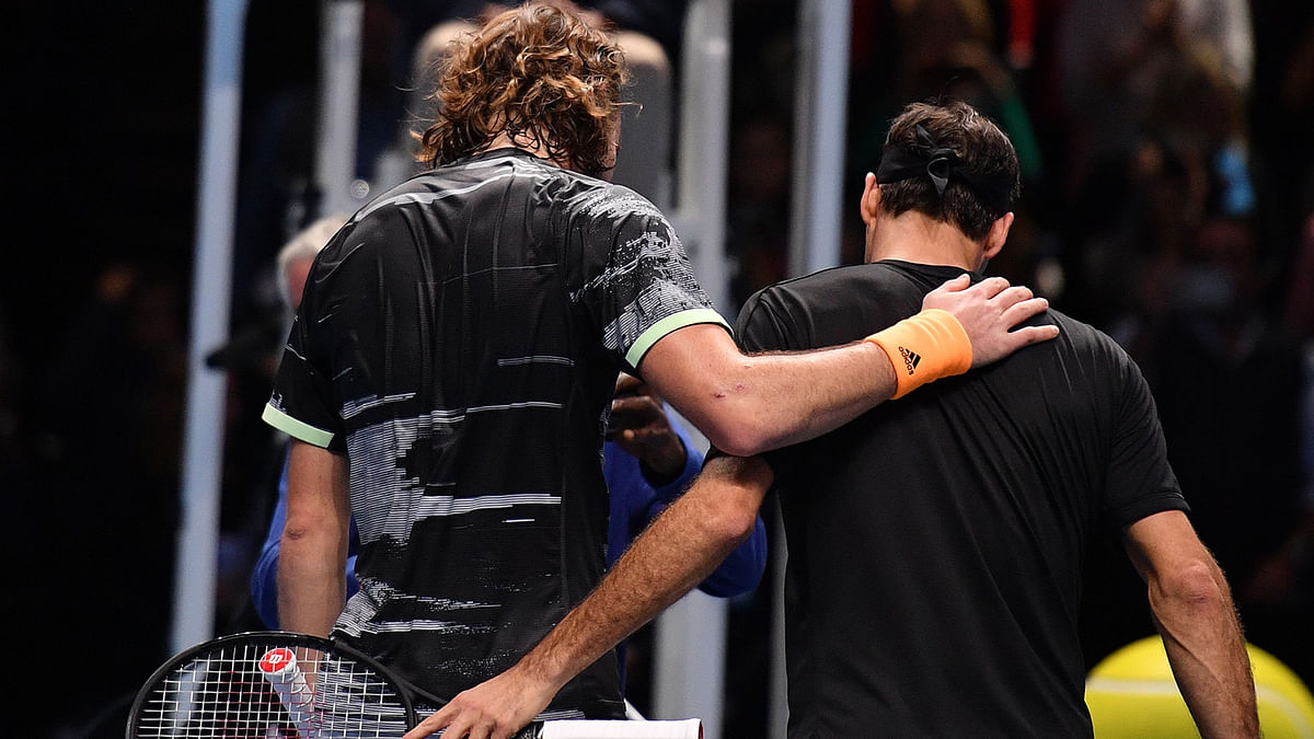 Greece`s Stefanos Tsitsipas (L) shakes hands as he celebrates victory against Switzerland`s Roger Federer (R) during the men`s singles semi-final match on day seven of the ATP World Tour Finals tennis tournament at the O2 Arena in London on 16 November 2019. Photo: AFP