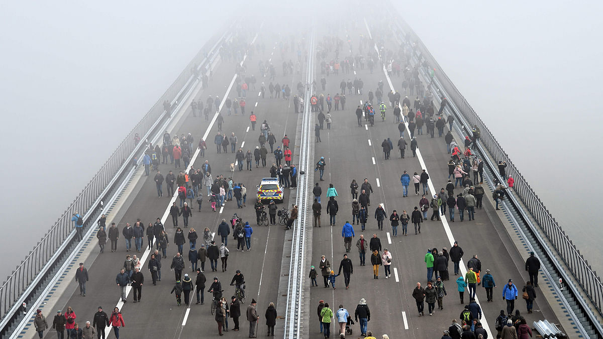 People walk on the Hochmosel Bridge ahead the opening of the bridge after eight years of construction in Zeltingen-Rachtig, on 16 November 2019. Photo: AFP