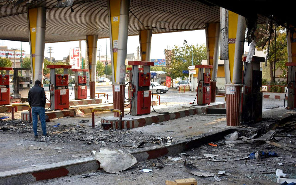 An Iranian man checks a scorched gas station that was set ablaze by protesters during a demonstration against a rise in gasoline prices in Eslamshahr, near the Iranian capital of Tehran, on 17 November. Photo: AFP