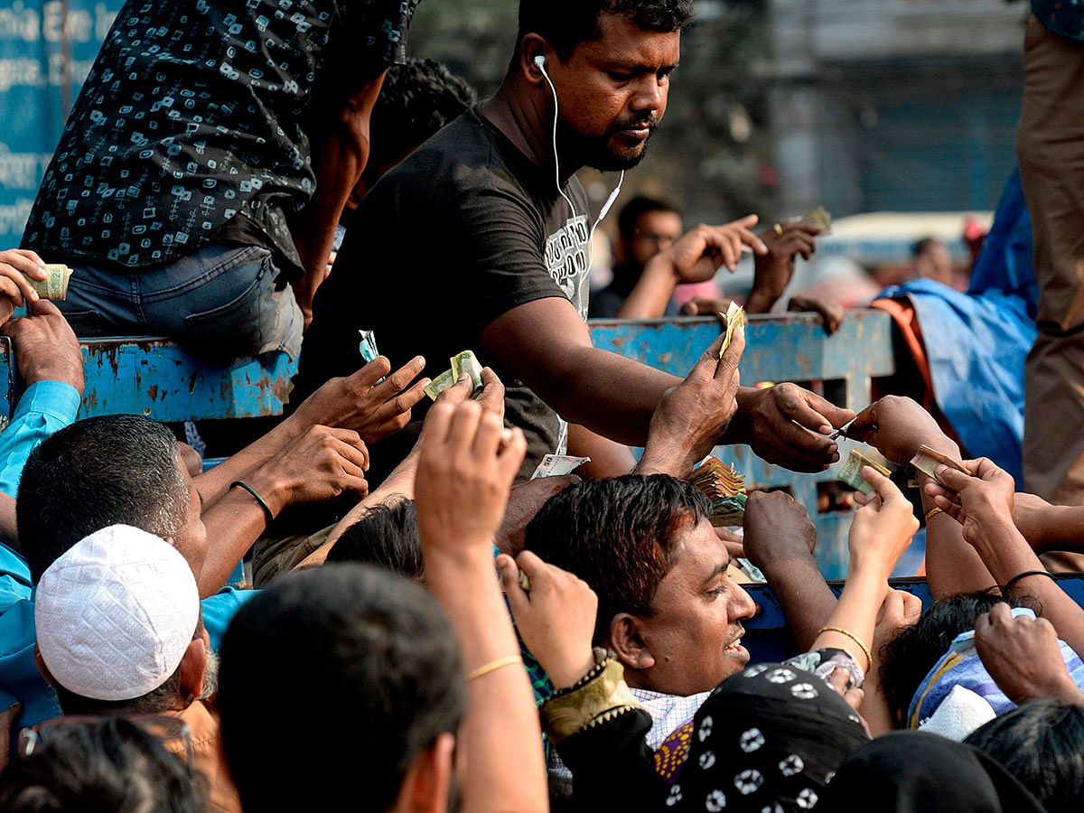 People scuffle as they purchase subsidised onions in Dhaka on 17 November 2019. Photo: AFP