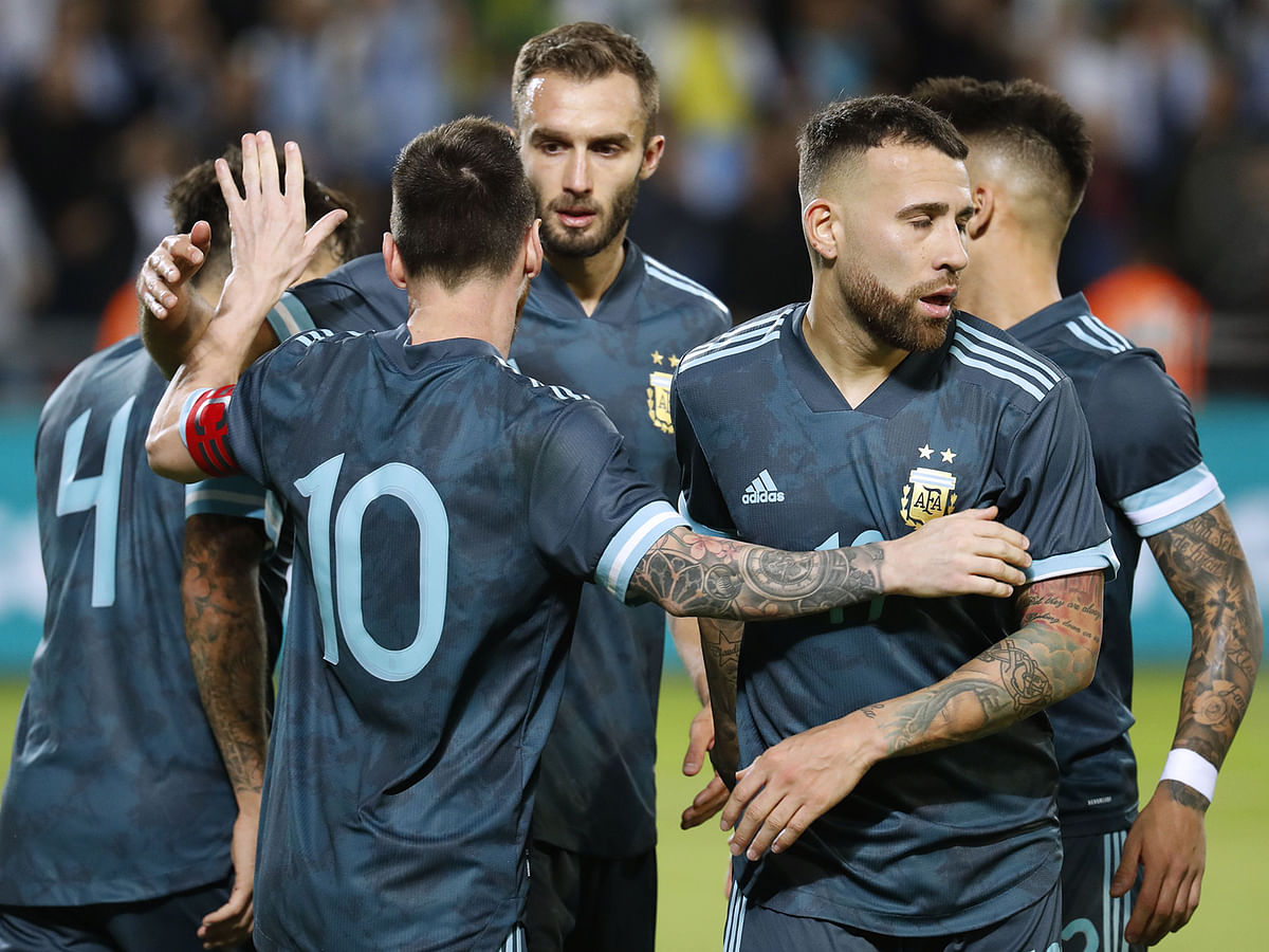 Argentina`s forward Lionel Messi celebrates with team mates after scoring during the friendly football match between Argentina and Uruguay at the Bloomfield stadium in the Israeli coastal city of Tel Aviv on Sunday. Photo: AFP