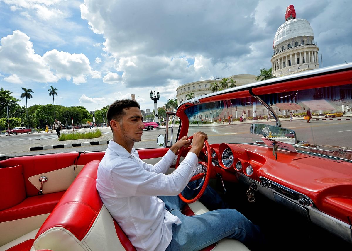 Cuban Yosbel Sosa, 33, drives his Chevrolet Impala `59 through the streets of Havana, on 20 August 2019, in search of tourists. Photo: AFP