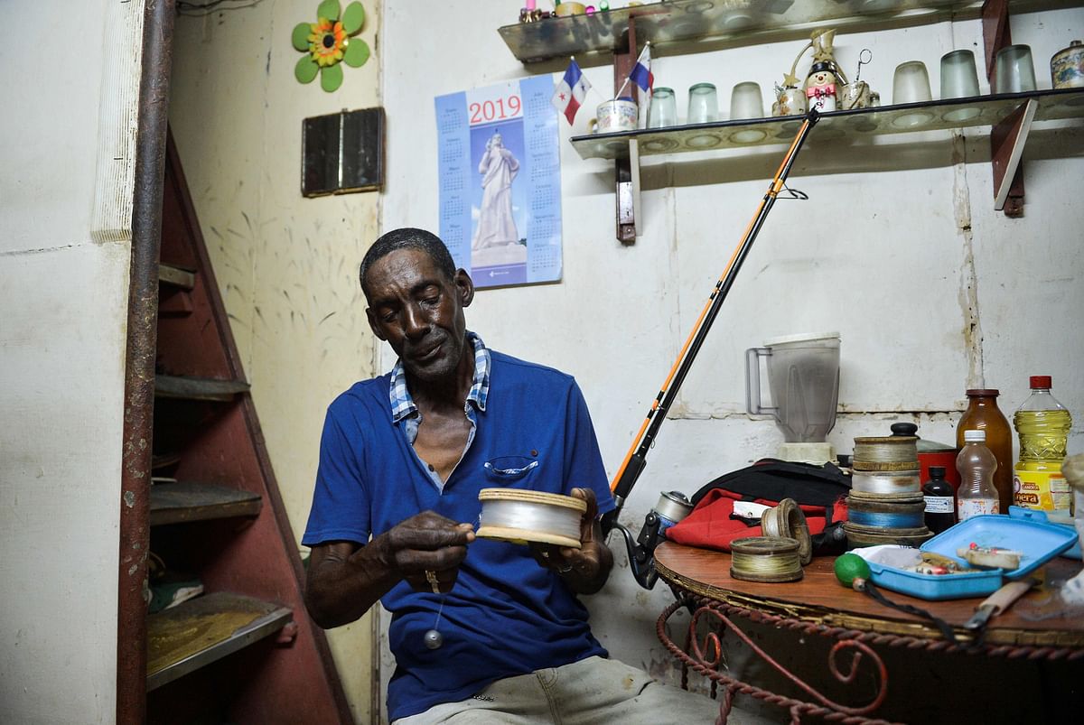 Cuban fisherman Roberto Molina, 69, prepares his fishing instrumentsat his home in Havana on 27 August 2019. Photo: AFP