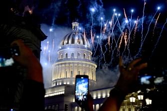 Cubans observe fireworks from the National Capitol in Havana, on 16 November 2019, to celebrate the 500 Anniversary of foundation of the city. Photo: AFP