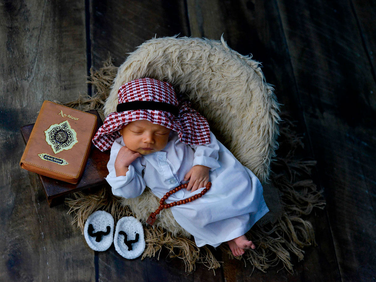 A newborn baby poses during a photo session in Banda Aceh on 18 November 2019. Photo: AFP