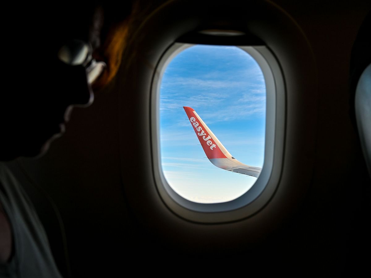 In this file photo taken on 13 October shows a partial view of the wing of an EasyJet aircraft flying over the northern region. Photo: AFP