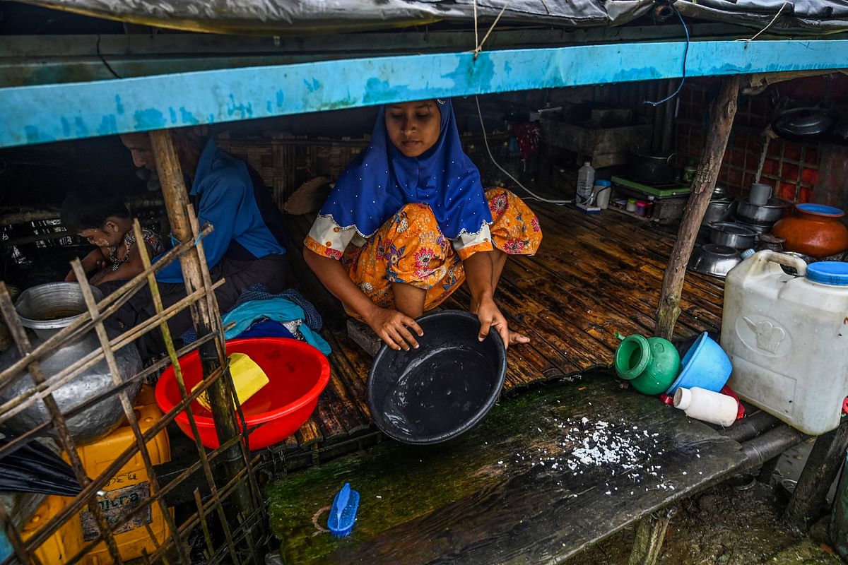 This photo taken on 3 October shows a Muslim woman cooking in her tent in Kyauktalone camp in Kyaukphyu, Rakhine state, where Muslim residents have been forced to live for seven years after the inter-communal unrest tore apart the town. Photo: AFP