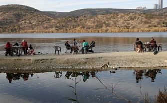 People sit at tables at Eymir Lake in Ankara in autumn on 14 November 2019. Photo: AFP