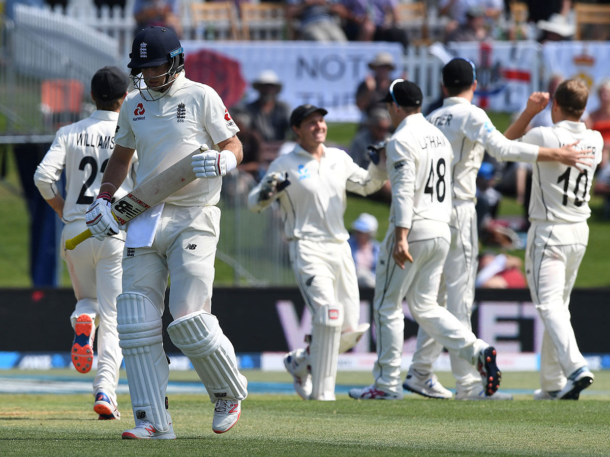 New Zealand`s Neil Wagner and Tim Southee celebrate with team mates while England`s Joe Root looks dejected after losing his wicket in the First Test against New Zealand at Bay Oval, Mount Maunganui, New Zealand on 21 November 2019. Photo: Reuters