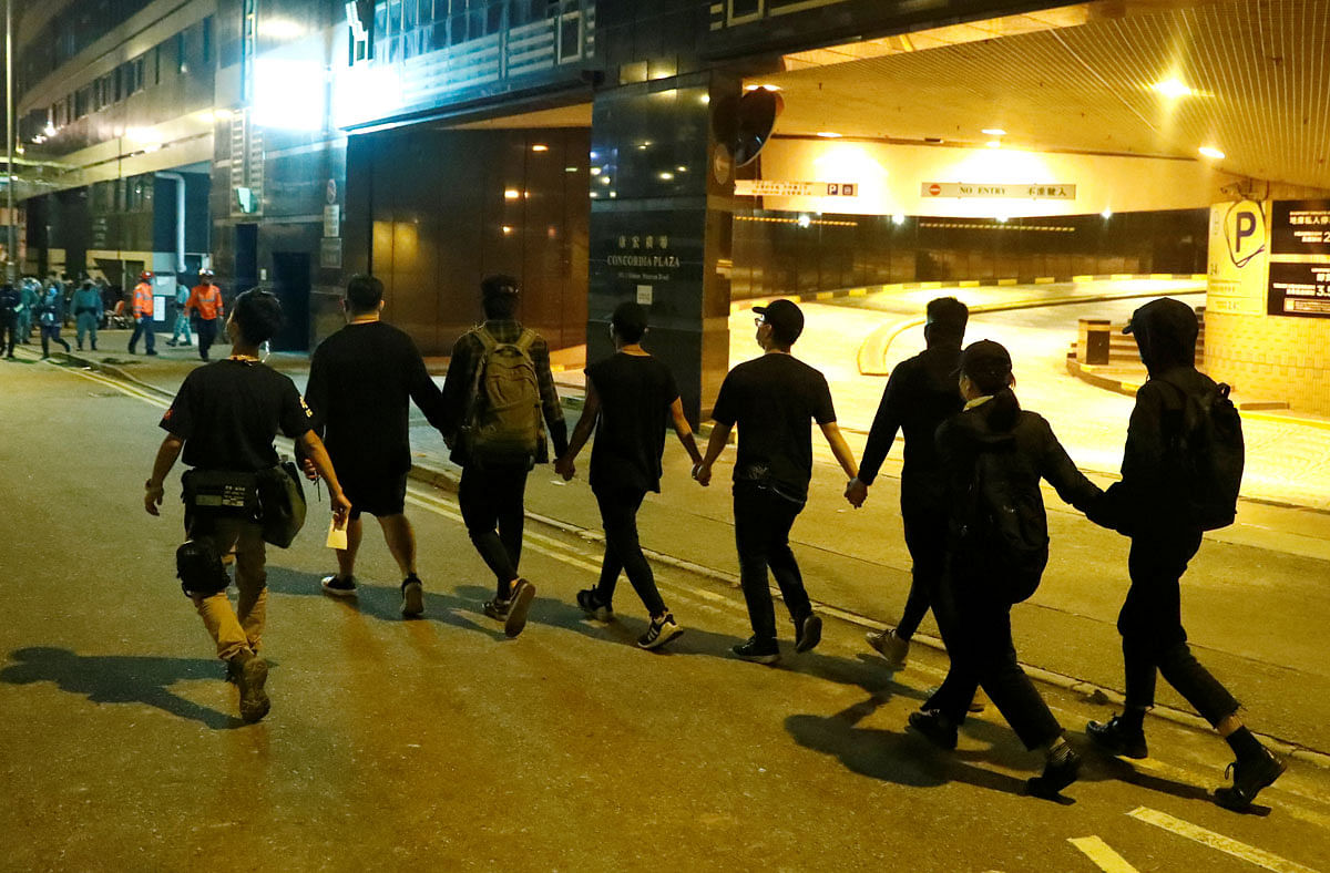 Anti-government protesters leave the campus of the Polytechnic University (PolyU) to give themselves up to the police in Hong Kong. Photo: Reuters