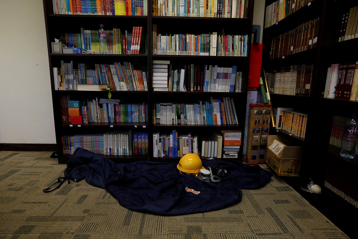A helmet, gas mask, and sleeping of a protester is left behind in the library of in Hong Kong Polytechnic University (PolyU) in Hong Kong. Photo: Reuters