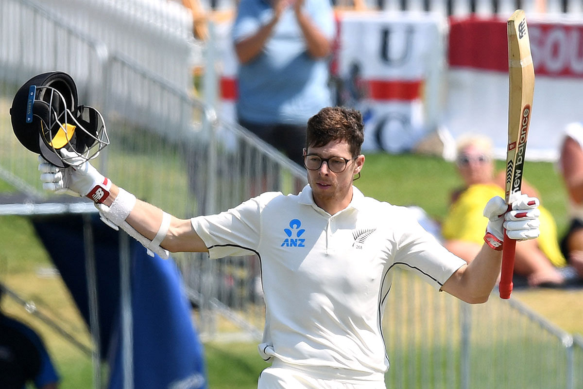 New Zealand`s Mitchell Santner celebrates his century in the first Test against New Zealand at Bay Oval, Mount Maunganui, New Zealand on 24 November 2019. Photo: Reuters