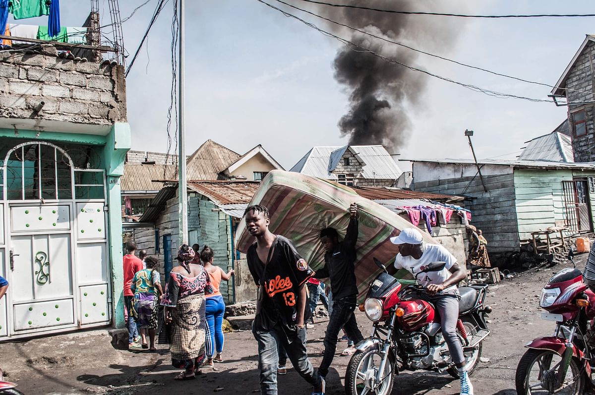 Smoke raises after a small aircraft carrying around 15 passengers crashed in a densely populated area in Goma on the East of the Democratic Republic of Congo on 24 November 2019. Photo: AFP