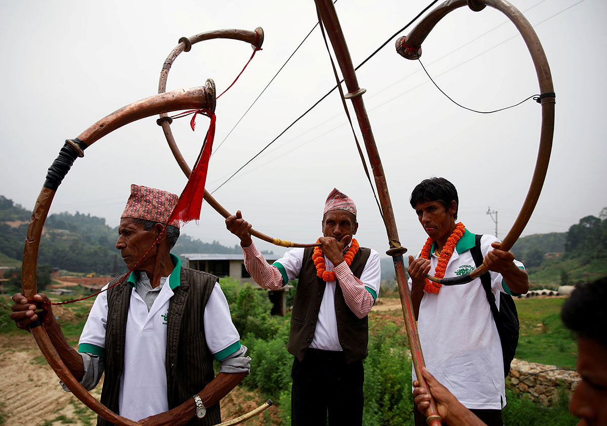 Villagers play traditional musical instruments during an event celebrating National Paddy Day, also called Asar Pandra, that marks the commencement of rice crop planting in paddy fields as monsoon season arrives, in Dhading, Nepal, on 30 June 2019. Reuters File Photo
