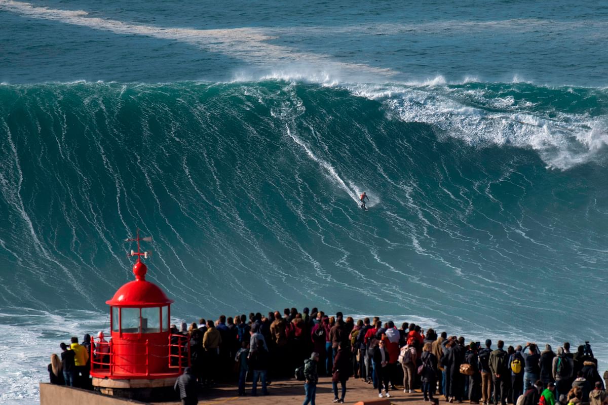 Brazilian surfer Rodrigo Koxa rides a wave during a free surfing session in Nazare, on 20 November 2019, waves reached between 15 and 20mt high. Nazare host one the two big waves surfing contest in the world, with waves reaching up to 30 meters at winter time. Photo: AFP