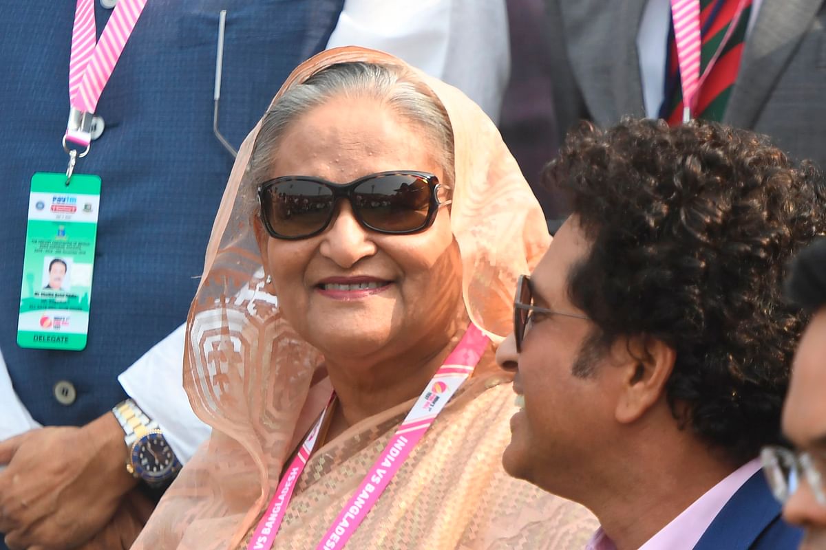 Bangladesh`s prime minister Sheikh Hasina (L) and former Indian cricketer Sachin Tendulkar attend a ceremony before the start of the first day of the second Test cricket match of a two-match series between India and Bangladesh at The Eden Gardens cricket stadium in Kolkata on 22 November 2019. Photo: AFP