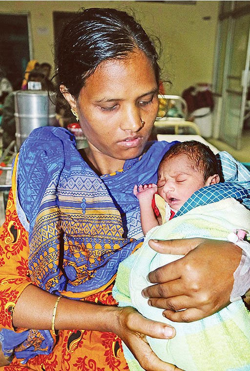 Nabia Begum, a woman who gave birth to a baby boy on a running train on Monday, poses with her newborn at Shaheed Ziaur Rahman Medical College Hospital in Bogura on 25 November 2019. Photo: Shoel Rana