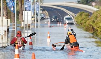 Two men paddle their kayaks through a flooded road in Palavas-les-Flots following overnight storm in southern France, on 23 November 2019. Photo: AFP