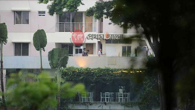 A foreigner, followed by two hostage-takers, walks on the roof of Holey Artisan Bakery around 6:30am. Prothom Alo file photo taken by Zahidul Karim
