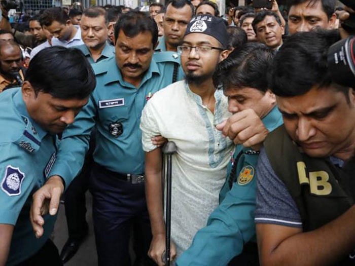 Convicted militant Rakibul Hassan Rigan wears cap with emblem of Islamic State after a Dhaka court delivered verdict on Holey Artisan attack case on Wednesday. Photo: Dipu Malakar