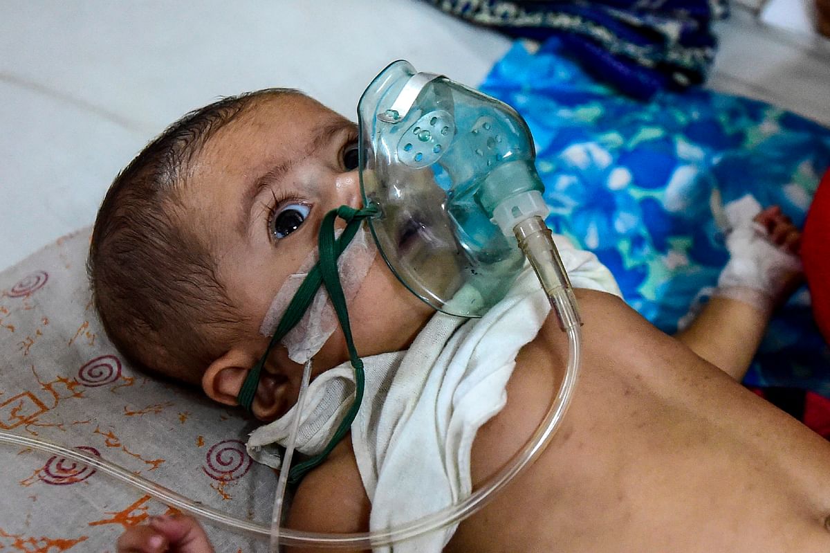 A baby who is suffering from respiratory disease receives treatment at Dhaka Shishu (Children) Hospital in Dhaka on 26 November 2019. Photo: AFP