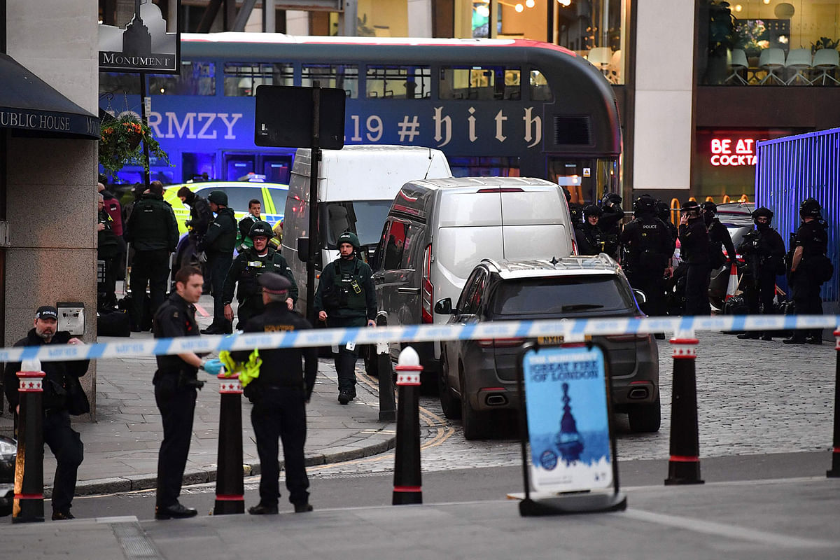 Police gather near The Monument in central London, on 29 November, 2019, after reports of shots being fired on London Bridge. Photo: AFP