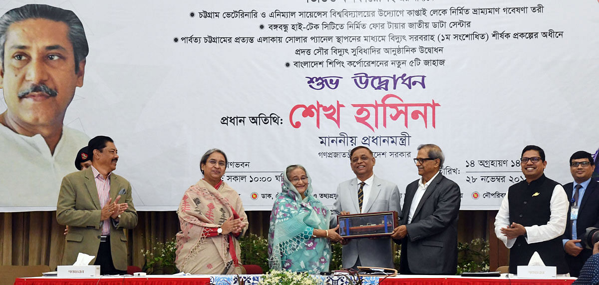 Shipping secretary hands over a replica of a ship after prime minister Sheikh Hasina commissioned five new ships of Bangladesh Shipping Corporation through videoconference from her official Ganabhaban residence in Dhaka on Thursday. Photo: PID