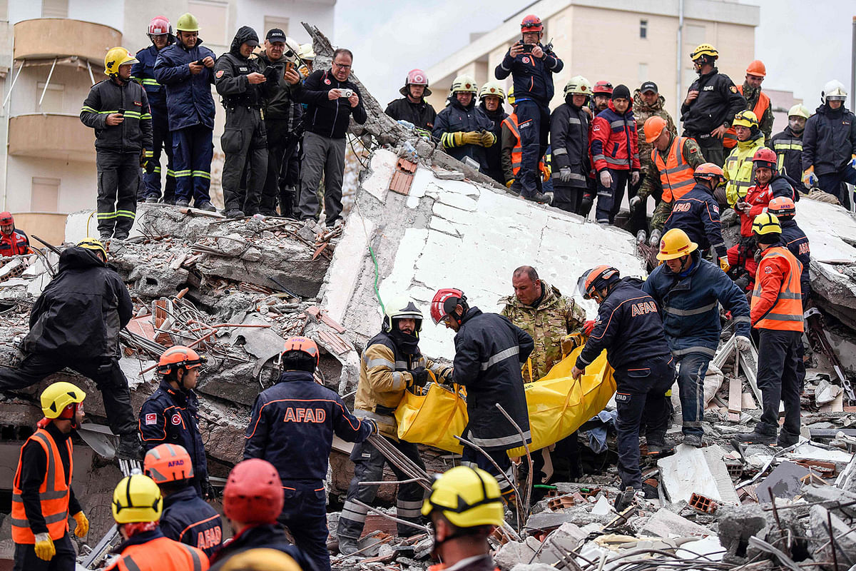 Rescue teams and firefighters carry a victim found under the rubble of a collapsed building in the town of Durres, western Albania on 28 November, 2019, after the strongest earthquake in decades hit the country. Photo: AFP.